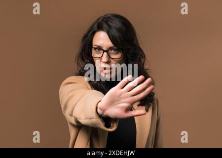 Uninterested businesswoman disapproving with NO finger sign. Denying, rejecting Stock Photo