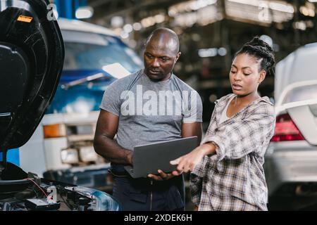 Garage Mechanic African Black male professional working car auto service checking engine oil Stock Photo