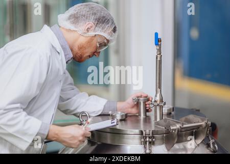 Scientist staff working with Equipment in Science Lab. Medical factory staff. Pharmaceutical Plants Process. Stock Photo