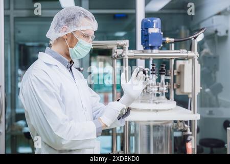 Scientist staff wearing Latex Medical Glove in Science Lab. Medical factory staff in clean room. Pharmaceutical Plants Process. Stock Photo