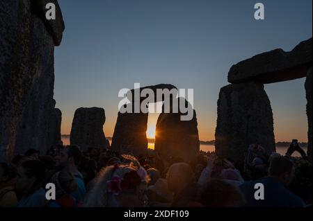 Salisbury Plain, Wiltshire, Friday, 21st June 2024.  Early morning Sun shines through the sacred stones at Stonehenge on the morning of the Summer Solstice. Credit: DavidJensen / Alamy Live news Stock Photo