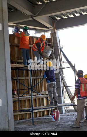 Mexican construction workers cement pouring concrete Stock Photo