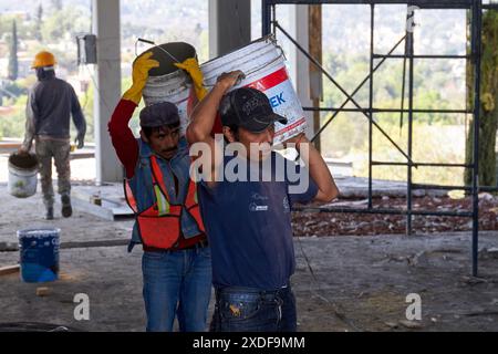 Mexican construction workers cement pouring concrete Stock Photo