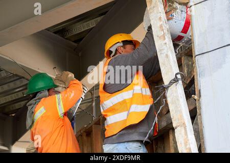 Mexican construction workers cement pouring concrete Stock Photo