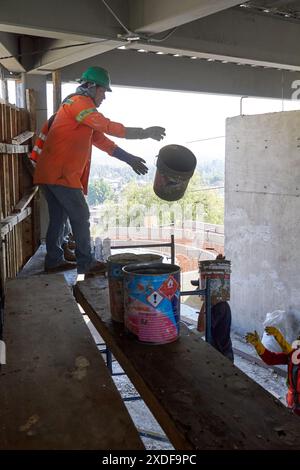 Mexican construction workers cement pouring concrete Stock Photo