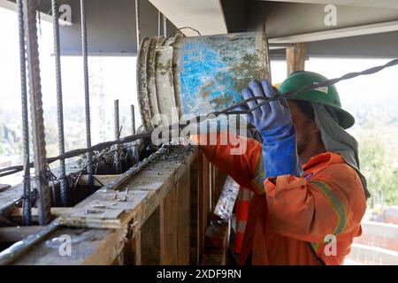 Mexican construction workers cement pouring concrete Stock Photo