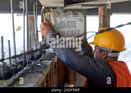 Mexican construction workers cement pouring concrete Stock Photo