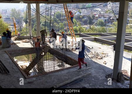 Mexican construction workers cement pouring concrete Stock Photo