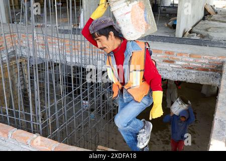 Mexican construction workers cement pouring concrete Stock Photo