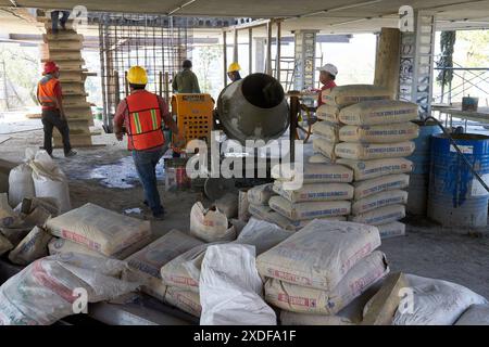 Mexican construction workers cement pouring concrete Stock Photo