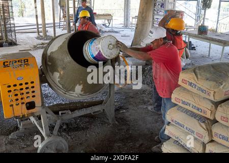 Mexican construction workers cement pouring concrete Stock Photo