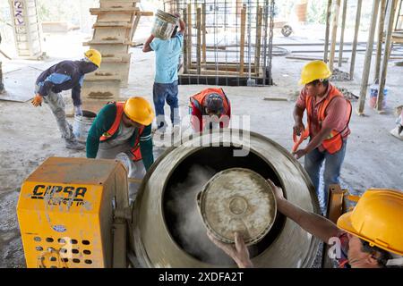 Mexican construction workers cement pouring concrete Stock Photo