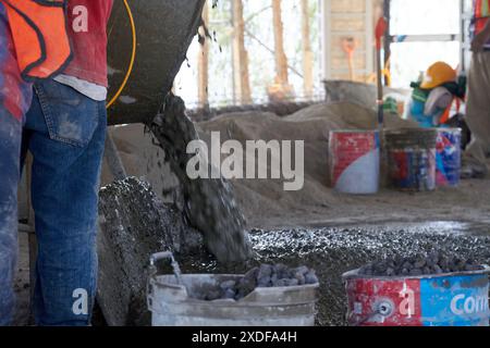 Mexican construction workers cement pouring concrete Stock Photo