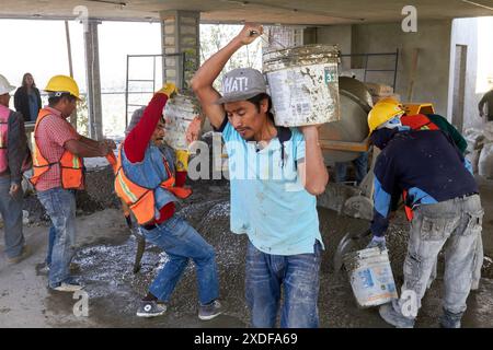 Mexican construction workers cement pouring concrete Stock Photo