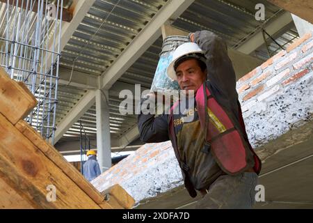 Mexican construction workers cement pouring concrete Stock Photo
