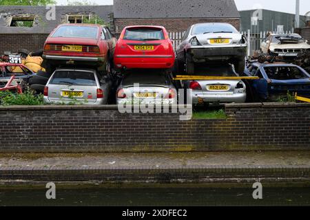 A pile of cars in scrap yard Wryly & Essington Canal, Wolverhampton, West Midlands, UK.  2 May 2024 Stock Photo