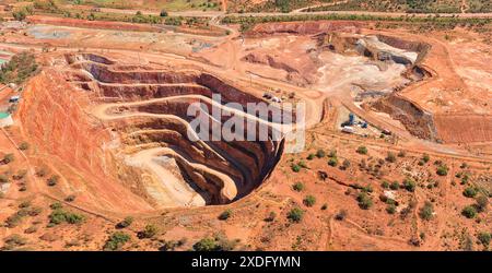 Deep open pit copper ore mine in Cobar town of NSW, Australia - aerial top down view. Stock Photo