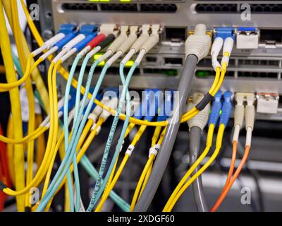 Communication equipment connected with copper and optical cables Stock Photo