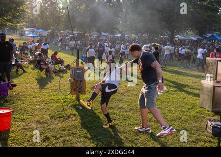 Baltimore, Maryland, USA. 22nd June, 2024. A friend keeps another friend from falling over as Busta Rhymes performs at the AFRAM (African-American Food, Music, Arts and Crafts) festival, Saturday, June 22, 2024 in Baltimore, Maryland. Baltimore reached 101 degrees, breaking the previous record high for the date of 100 set in 1988. (Eric Kayne/Zuma Press Images) @photokayne (Credit Image: © Eric Kayne/ZUMA Press Wire) EDITORIAL USAGE ONLY! Not for Commercial USAGE! Stock Photo