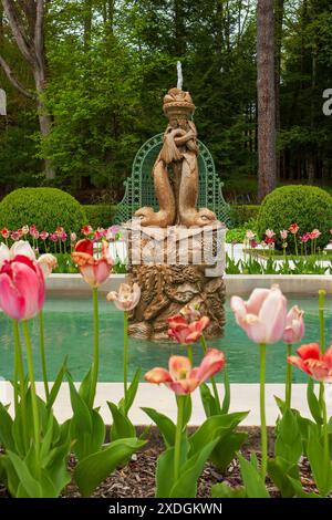 The French Flower Garden at The Mount, Edith Wharton's country house in Lenox, MA, featuring a stone fountain surrounded by vibrant flowers. Stock Photo