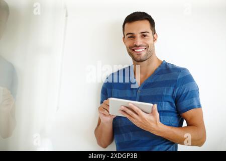 Creative designer, tablet and smile portrait for project, planning and reading information or solution on website. Young man or business freelancer Stock Photo