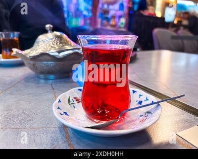 Istanbul, Turkey - May 5, 2024: Sipping tradition in a cup of Turkish tea. Stock Photo
