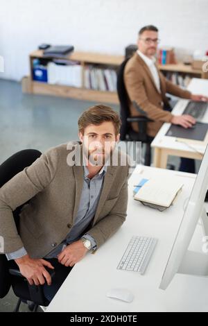 Businessman, desk and portrait in office, table and coworking of colleagues, computer and together. Above, working and entrepreneur in company Stock Photo