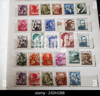 Philately collection: assorted used Italian postage stamps well aligned in their album Stock Photo