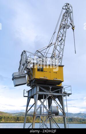 View of a port crane in the old industrial area of the town of San Esteban de Pravia, Asturias (Spain) Stock Photo