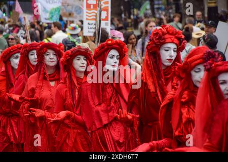 London, UK. 22nd June, 2024. Extinction Rebellion's Red Rebels take part in the Restore Nature Now march. Tens of thousands of people and numerous nature and wildlife groups marched in Central London, calling on the government to do more to restore and protect nature and wildlife. Credit: SOPA Images Limited/Alamy Live News Stock Photo