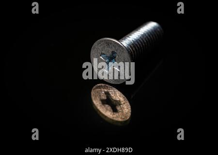Stainless plus bolt washer screwbolt on black background. Stock Photo