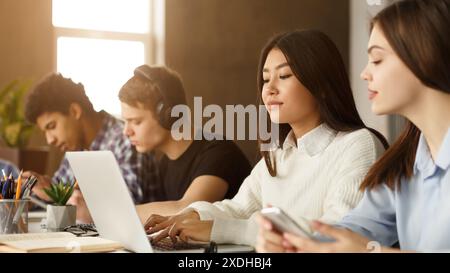 Multiracial students engaged in library study session Stock Photo