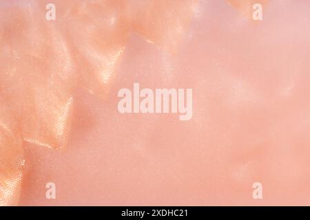 pink leaves on pink Shiny Abstract Background. Paints, Acrylic, Glitter in Water. pink leaves in pink Shiny Liquid Surface, Ripples, Waves. Stock Photo