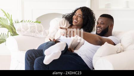 Happy Couple Relaxing On Couch Stock Photo