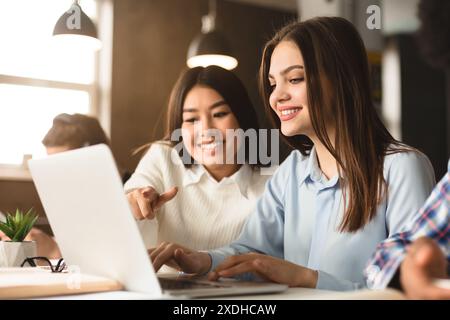 Two Women Collaborating on Project in Library Environment During Daytime Stock Photo