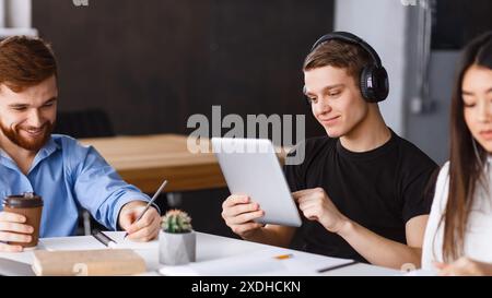 Young Adults Engaged in a Collaborative Work Session Stock Photo