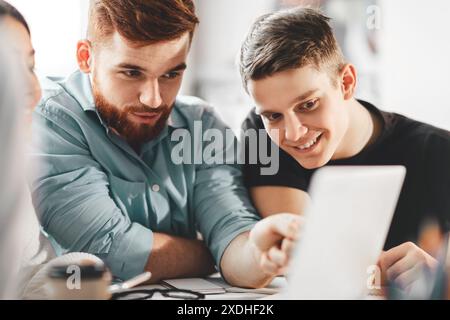Two Colleagues Collaborating on Project Using Tablet in Office Setting Stock Photo
