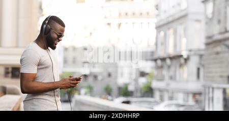 Man Listening to Music on Phone in City Stock Photo