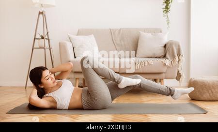 Woman Doing Ab Workout At Home Stock Photo