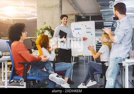 Young millennial team analyzing information on graphs and charts Stock Photo