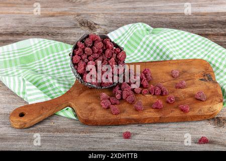 Dried strawberries. Bowl with dried strawberries on wooden table. Stock Photo