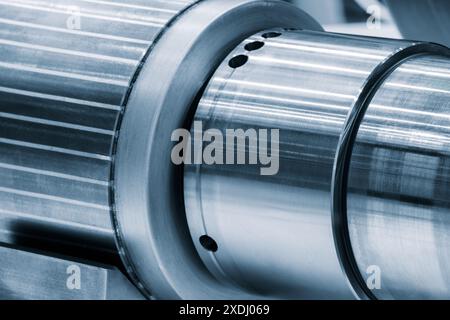 A silver metal tube with a lot of holes in it. The tube is very shiny and looks like it is made of metal Stock Photo