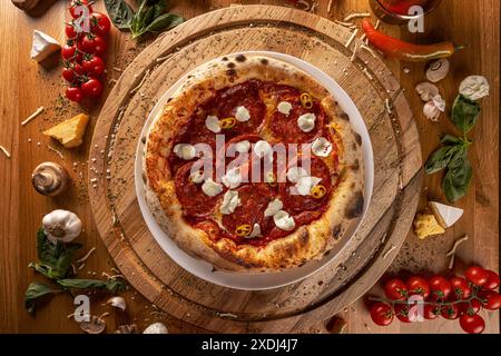 Delectable pepperoni pizza with fresh ingredients showcased on a rustic wood table setting Stock Photo