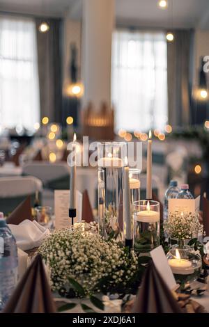 Warm candlelit table setting creates a romantic atmosphere at a wedding table Stock Photo