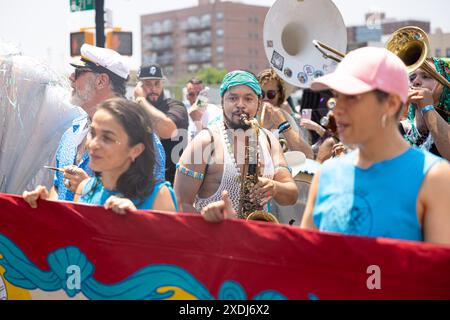 Participants of the 42nd Annual Mermaid Parade perform at Coney Island in New York, NY on June 22, 2024. Since 1983, hundreds of thousands of New Yorkers and visitors have come to participate in and watch this parade, inspired by Coney Island Mardi Gras parades of the past. Similar to past years, this year featured a wide range of festive costumes, makeup, floats, banners, music, and more. (Photo by Hailstorm Visuals/Sipa USA) Stock Photo