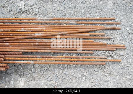 Bars of rebar laying on a gravel lot Stock Photo