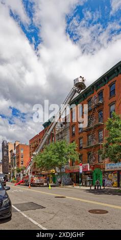 NYC Chinatown: Crew of FDNY Tower Ladder 18, Fort Pitt, practice their skills at 29 and 31 Canal Street. Stock Photo