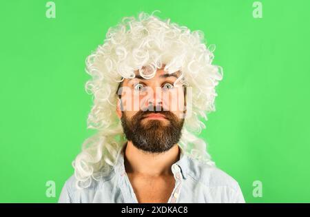 Portrait of bearded man in white wig. Stylish guy with beard and mustache in curly periwig. Barbershop advertising. Handsome male with white hair Stock Photo