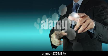 A businessman in a suit interacting with a virtual interface, symbolizing digital transformation and the use of technology in modern business operatio Stock Photo