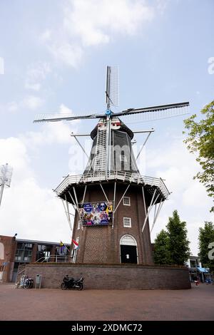 A historic windmill in the center of the town of Delfzijl on the northeastern coast of the Netherlands. Stock Photo